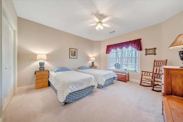 a spacious bedroom with a bed and a chandelier