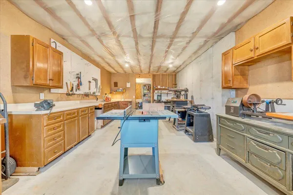 a large kitchen with lots of counter top space and stainless steel appliances