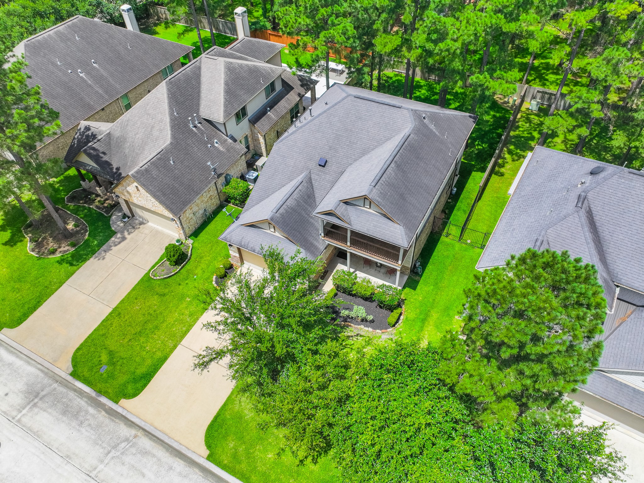 79 West Jagged Ridge Circle Spring, TX 77389 - Photo 47 of 50 Another aerial perspective highlights the consistent quality and care found throughout this neighborhood, with manicured lawns and mature trees lining the street. This kind of pride of ownership throughout the community adds lasting value to every home within it.
