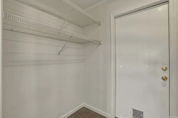 an empty room with a window and a ceiling fan