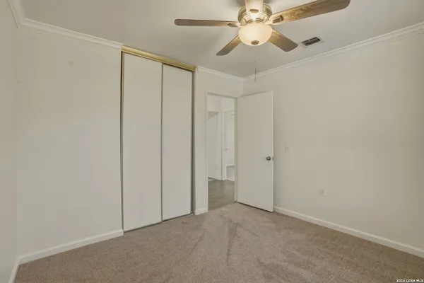 an empty room with fan and fan