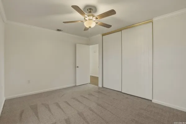 an empty room with fan and a ceiling fan