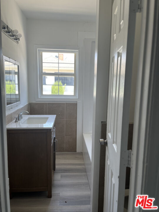 602 North Sloan Avenue Compton, CA 90221 - Photo 11 of 16 a bathroom with a sink and a mirror