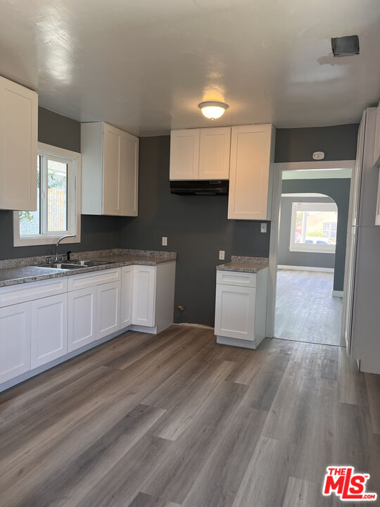 602 North Sloan Avenue Compton, CA 90221 - Photo 15 of 16 a kitchen with granite countertop a sink cabinets and wooden floor