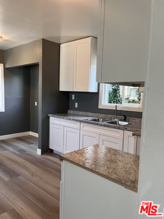602 North Sloan Avenue Compton, CA 90221 - Photo 16 of 16 a kitchen with granite countertop a sink and a stove top oven