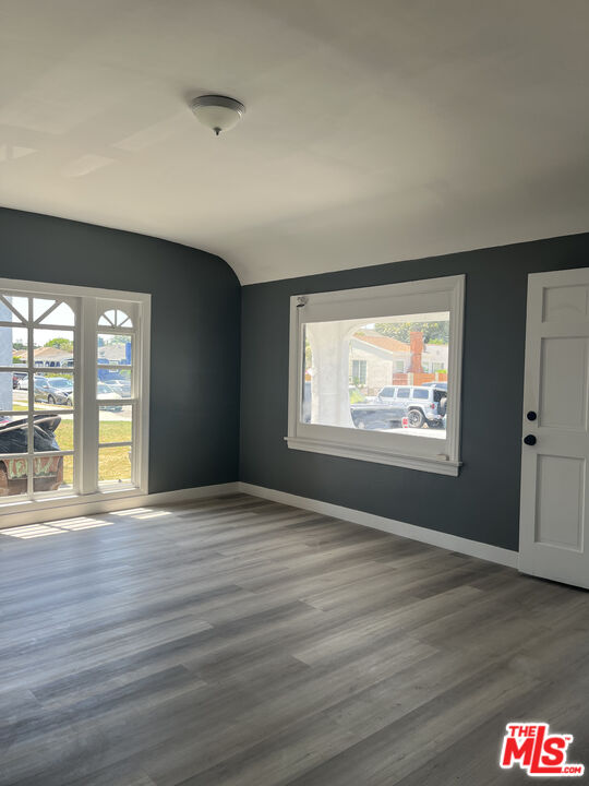602 North Sloan Avenue Compton, CA 90221 - Photo 3 of 16 a view of an empty room with wooden floor and a window