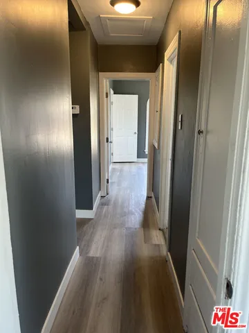 a view of hallway with wooden floor