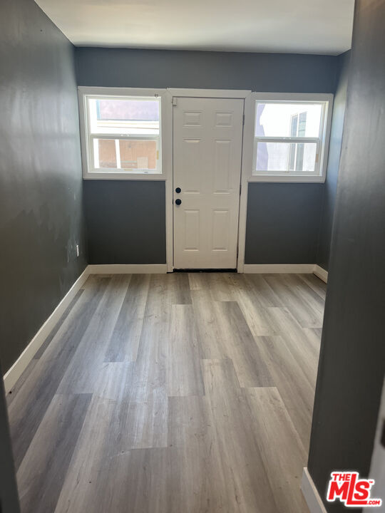 602 North Sloan Avenue Compton, CA 90221 - Photo 7 of 16 an empty room with wooden floor and windows