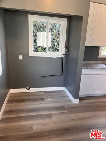 a view of a livingroom with wooden floor and a window