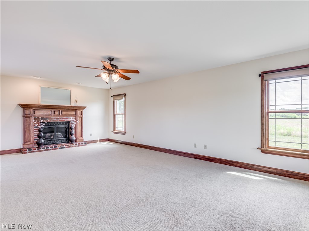 4840 Industry Road Ravenna, OH 44266 - Photo 10 of 32 Gas fireplace with wood mantle and brick surround. Fireplace and garage use propane.