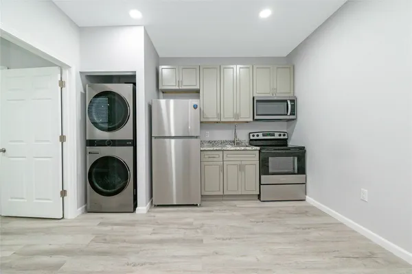 a utility room with sink dryer and washer