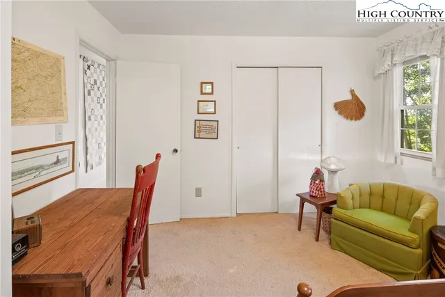 a living room with furniture a wooden floor and a window