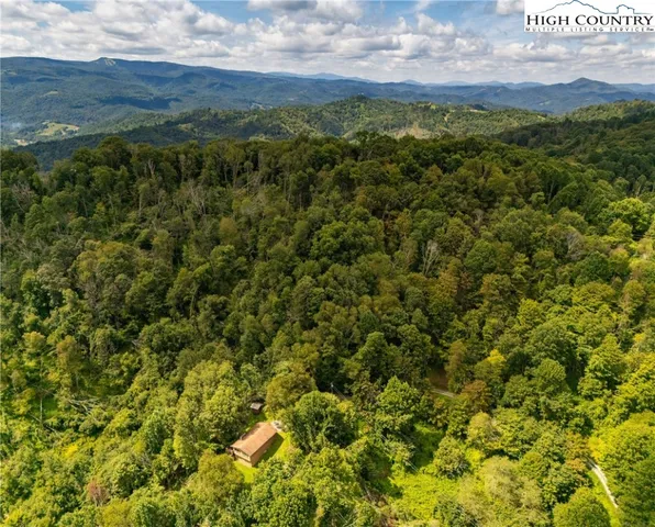 a view of a mountain range with lush green hillside