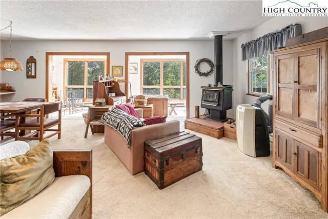 a living room with furniture and a floor to ceiling window