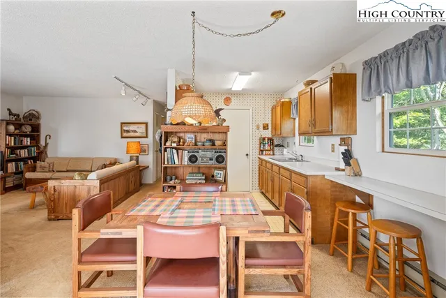 a large kitchen with a table and chairs