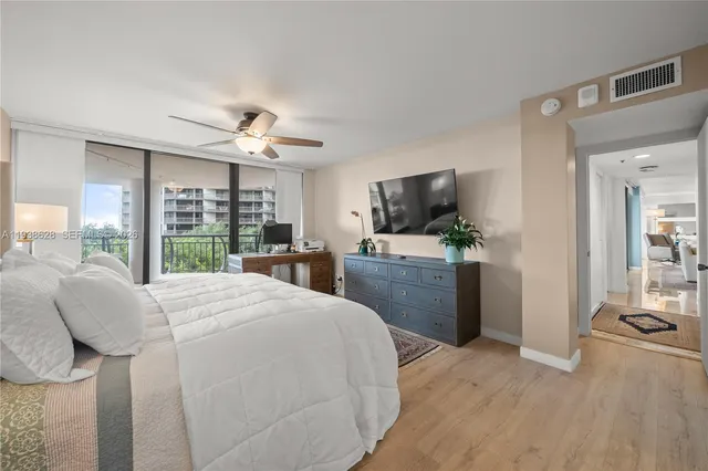a bed room with furniture and a flat screen tv