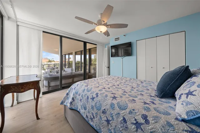 a bedroom with a large bed and a large window