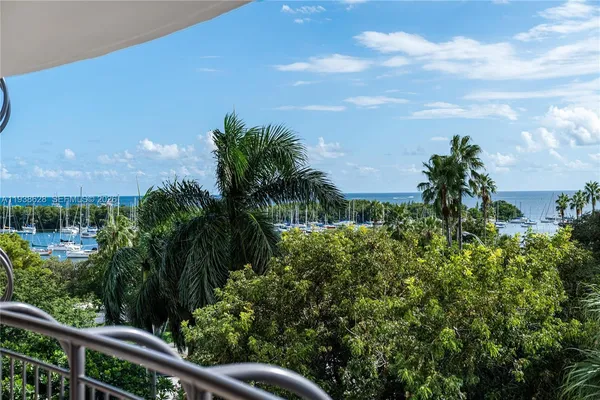 a view of a yard with plants and a building
