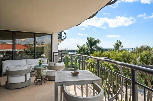 a view of balcony with couch and chairs