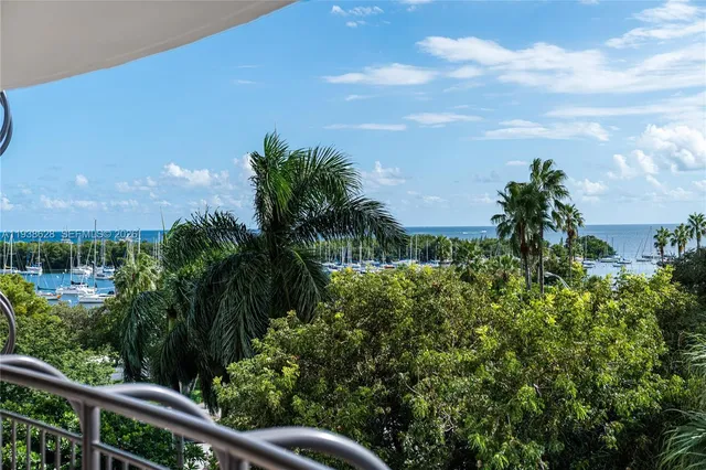 a view of a yard with plants and a building