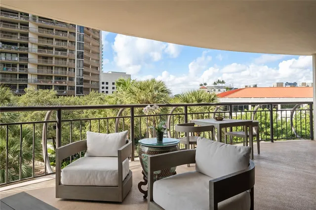 a view of a chairs and table in the balcony