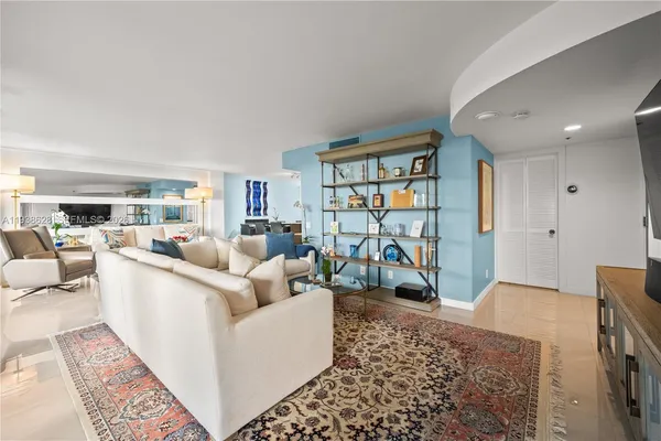 a living room with furniture a rug and a flat screen tv