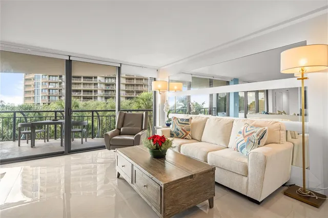 a living room with furniture and a large window with outer view