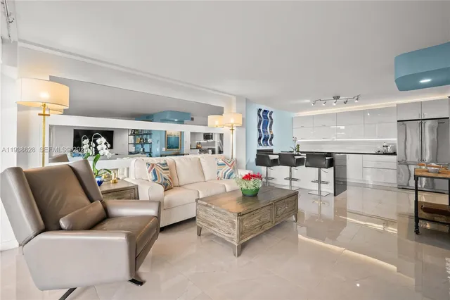 a living room with furniture and a view of kitchen