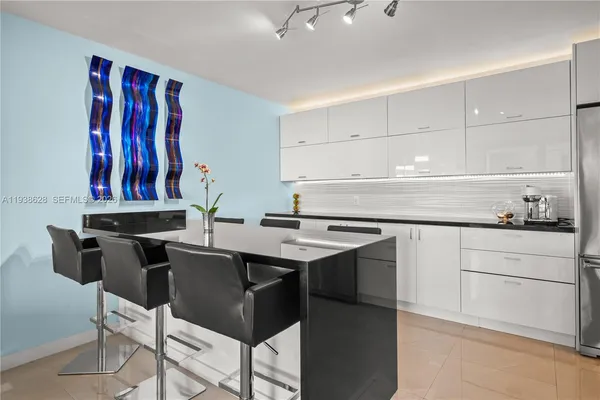 a kitchen with a sink a stove and a refrigerator