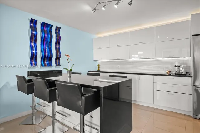 a kitchen with a sink a stove and a refrigerator