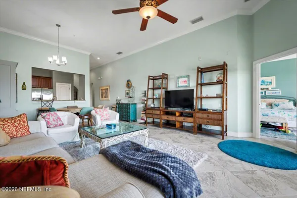 a bedroom with furniture and a flat screen tv