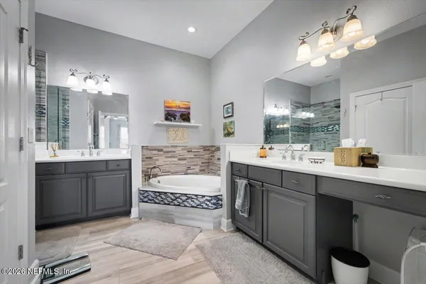 a bathroom with a sink double vanity and a mirror