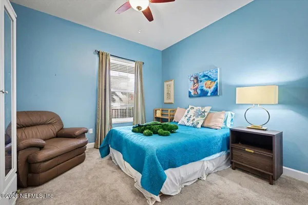 a bedroom with a bed and a couch