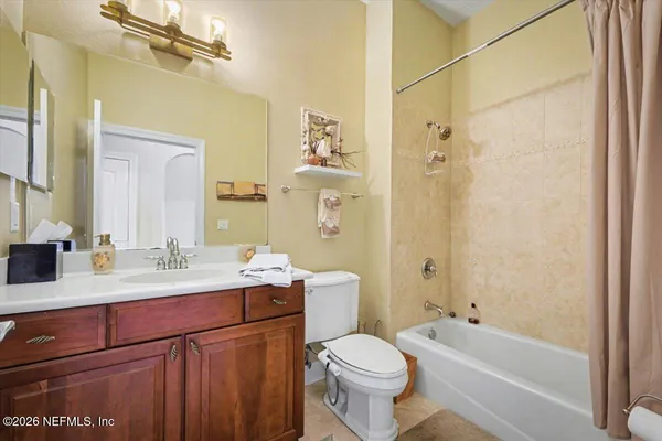 a bathroom with a double vanity sink toilet mirror and shower