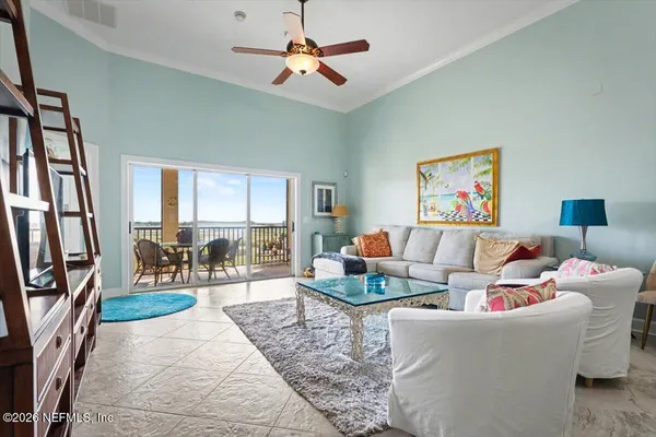a living room with furniture and a floor to ceiling window