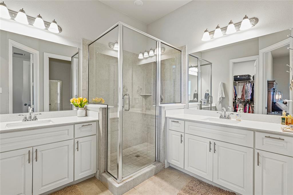 8010 Foraker Street Frisco, TX 75034 - Photo 11 of 14 a spacious bathroom with a shower sink and mirror