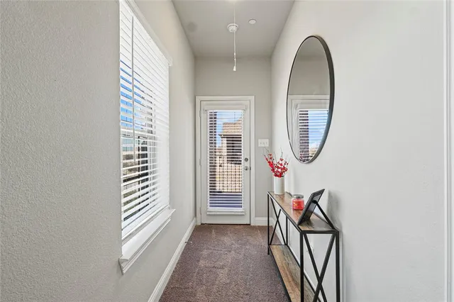 an entryway in wooden floor with windows