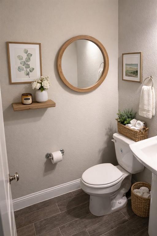 8010 Foraker Street Frisco, TX 75034 - Photo 12 of 17 a bathroom with a toilet a sink and mirror