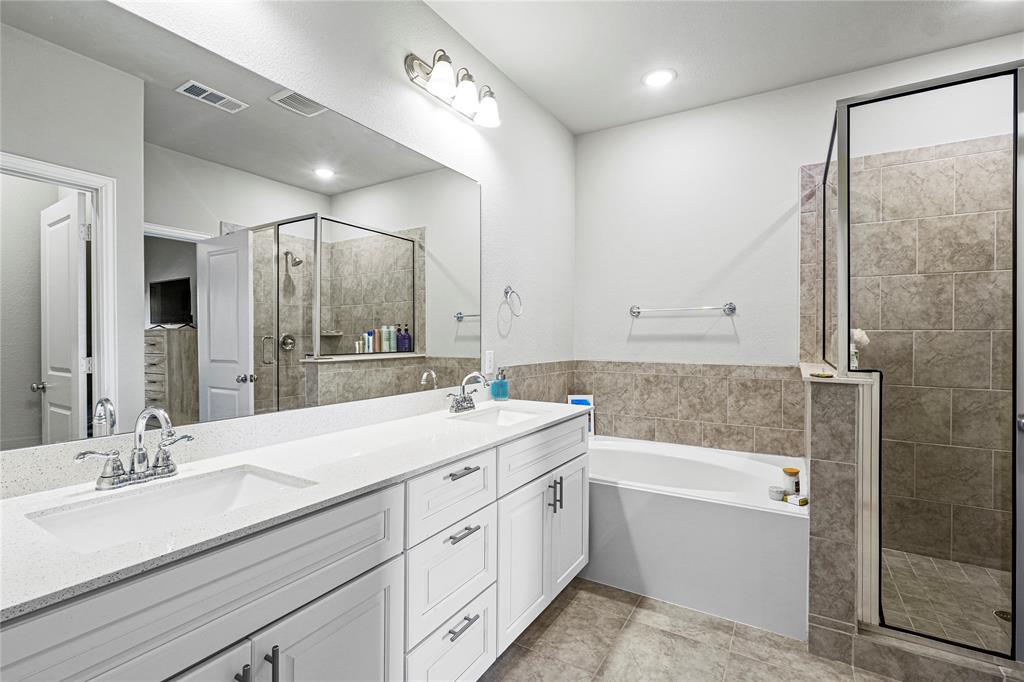 8010 Foraker Street Frisco, TX 75034 - Photo 13 of 14 a bathroom with a double vanity sink mirror double and bathtub