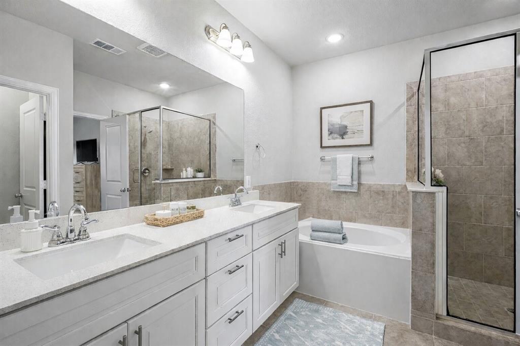 8010 Foraker Street Frisco, TX 75034 - Photo 14 of 17 a spacious bathroom with a double vanity sink mirror and bathtub