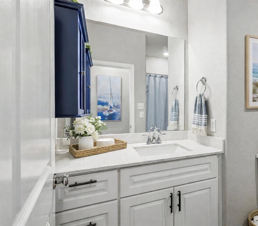 8010 Foraker Street Frisco, TX 75034 - Photo 4 of 17 a bathroom with a sink and a mirror