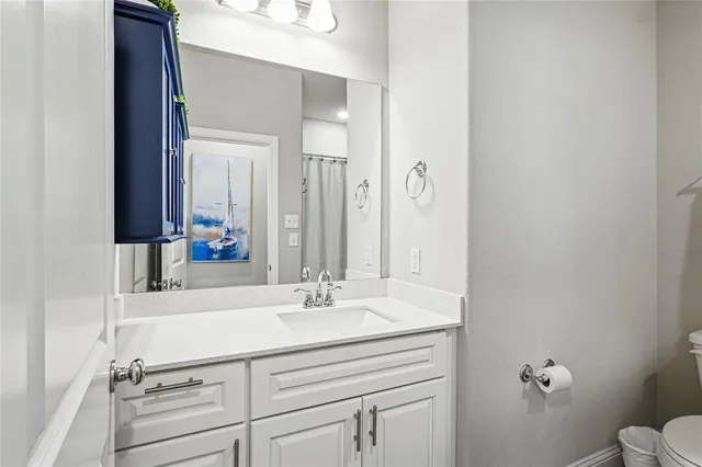 a bathroom with a sink vanity and a mirror