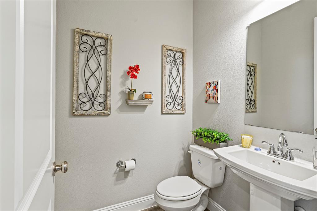 8010 Foraker Street Frisco, TX 75034 - Photo 8 of 13 a bathroom with a toilet a sink and a mirror