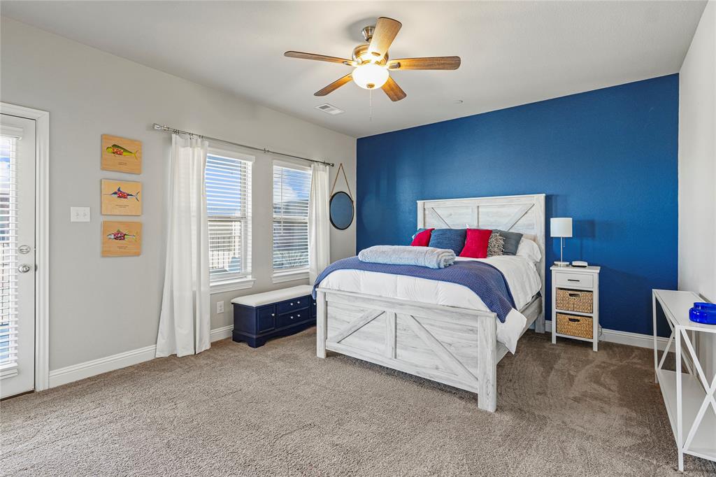 8010 Foraker Street Frisco, TX 75034 - Photo 8 of 14 a spacious bedroom with a bed and a chandelier
