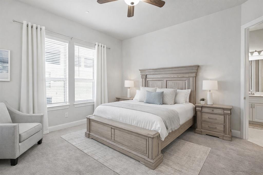 8010 Foraker Street Frisco, TX 75034 - Photo 9 of 17 a spacious bedroom with a bed a couch and a chandelier fan