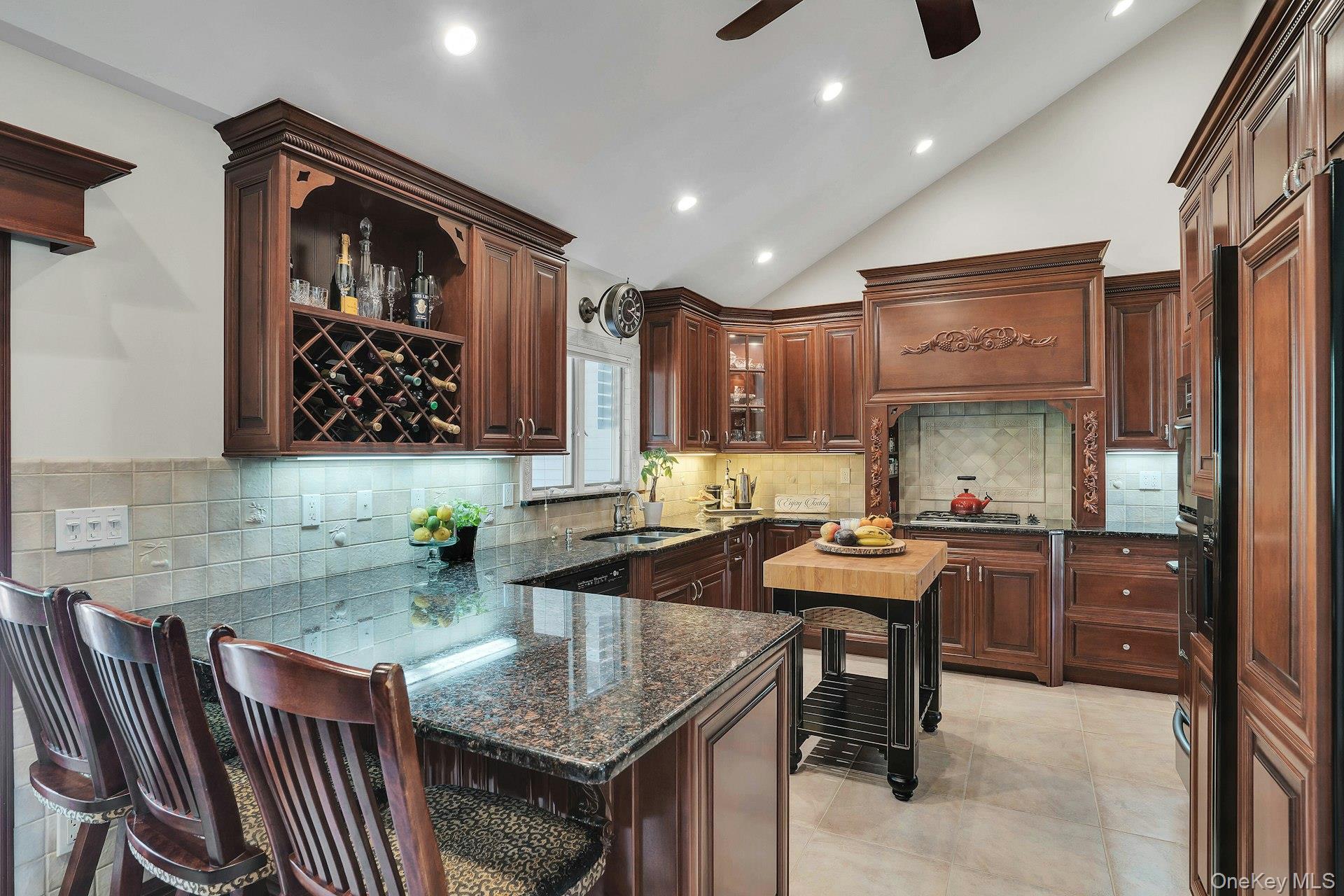 101 Hayrick Lane Commack, NY 11725 - Photo 12 of 50 a kitchen with a sink a stove and chairs