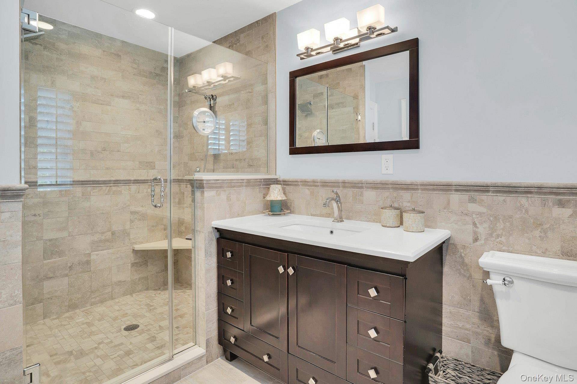 101 Hayrick Lane Commack, NY 11725 - Photo 24 of 50 a bathroom with a sink mirror and a shower