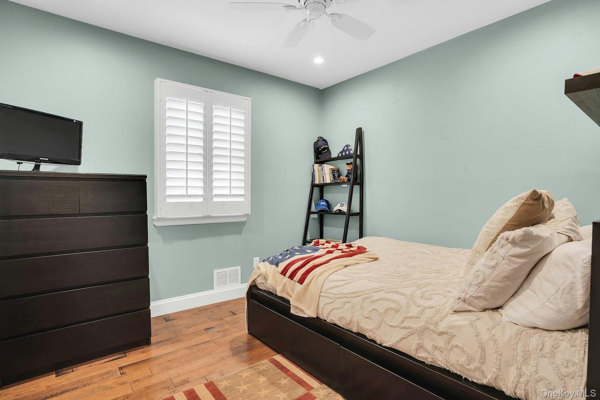 101 Hayrick Lane Commack, NY 11725 - Photo 25 of 50 a bedroom with a bed and a television