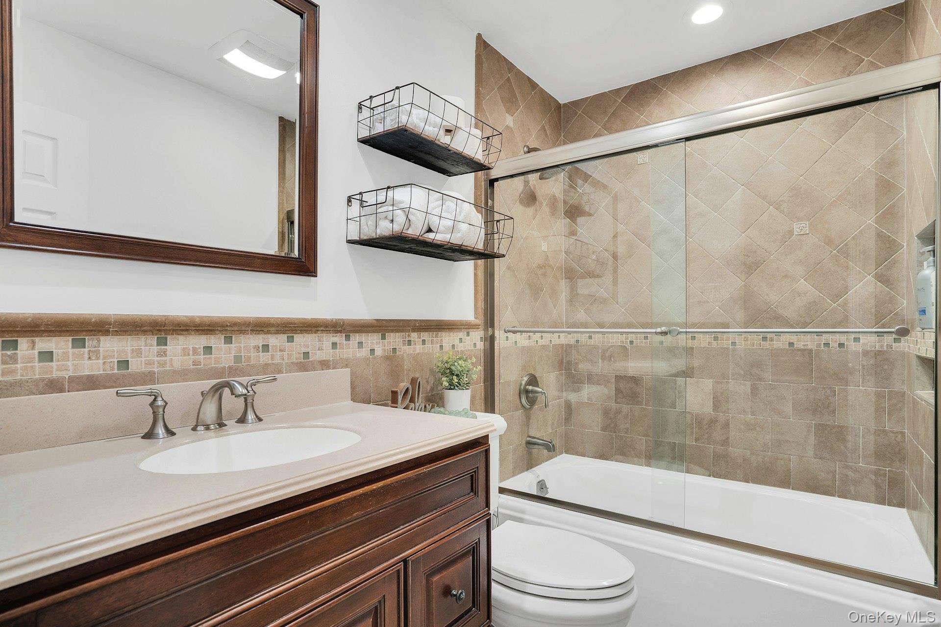 101 Hayrick Lane Commack, NY 11725 - Photo 27 of 50 a bathroom with a granite countertop sink a toilet a mirror and shower