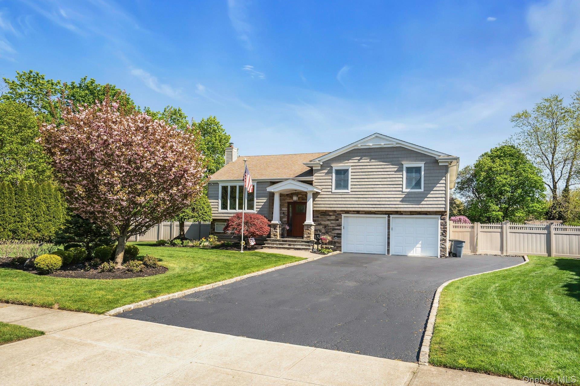 101 Hayrick Lane Commack, NY 11725 - Photo 3 of 50 a front view of a house with a yard and trees